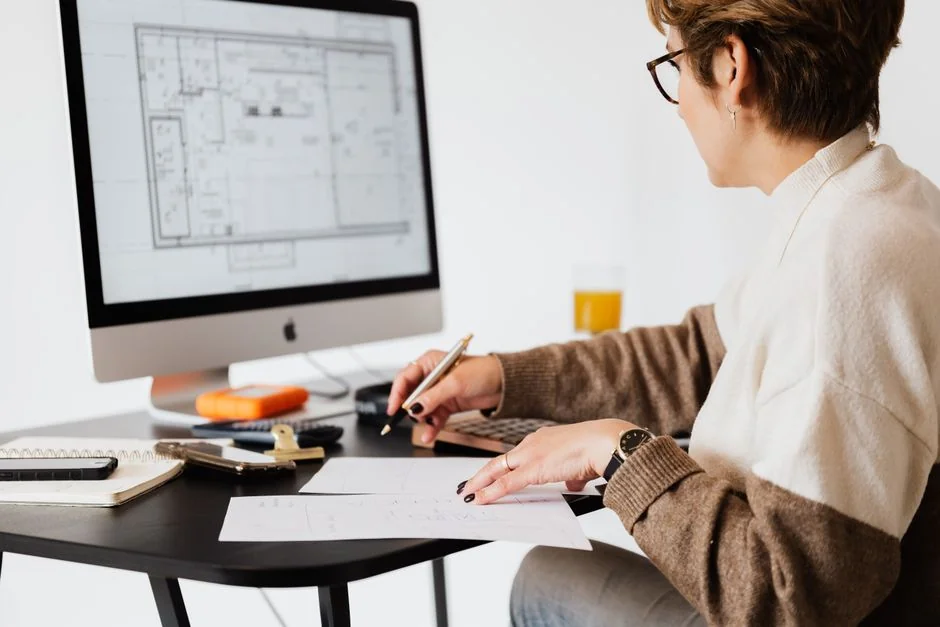 A modern computer screen displaying web design work, showcasing creative visuals in a workspace.